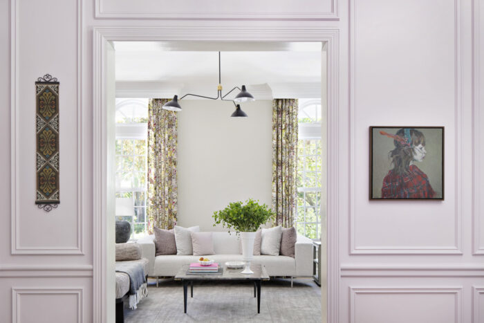 Bright seating area with floral patterned drapes, pastel accents, and layered textures.